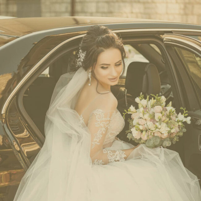 Bride out from a car on a wedding service rented on www.parisbyls.com luxury wedding chauffeur service